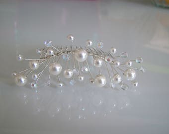 May include: A silver hair comb with white pearls and clear crystals arranged in a delicate, branching design.