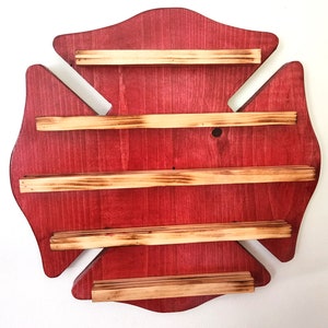 May include: Red wooden fire hydrant shaped shelf with five wooden shelves. The shelves are stained a light brown colour.