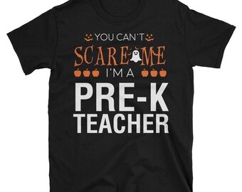 May include: Black t-shirt with the text "You can't scare me I'm a pre-k teacher" in white. The text is surrounded by orange pumpkins and a white ghost.