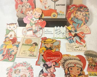 May include: A collection of vintage Valentine's Day cards featuring various illustrations including children, animals, and figures in headdresses. The cards display text such as I'll Stop For You Anytime, We Could Go Places Together, and I'm All Aquiver.