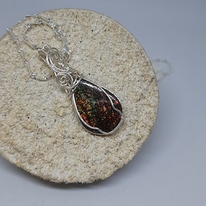 Colorful Canadian gem stone from Alberta display with lots of geens, oranges and golden color. Gem status was granted in 1981 image 1