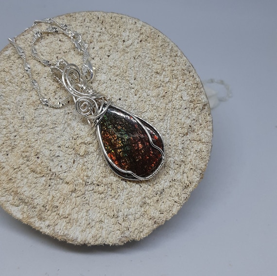 Colorful Canadian gem stone from Alberta display with lots of geens, oranges and golden color. Gem status was granted in 1981