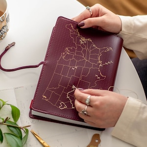 USA Stitch where you've been across the United States! Travel Notebook in Maroon vegan leather with gold map and needle & thread