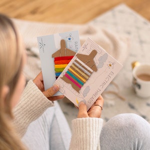 May include: Two cards with colourful embroidery floss wound around cardboard airplane shapes. The cards are labelled "Rainbow Threads" and "Electric Threads".