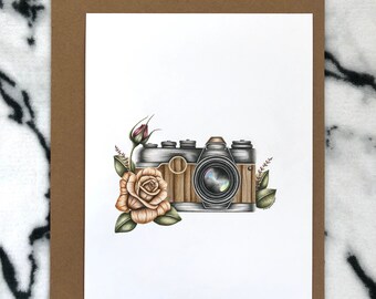 May include: A vintage camera with a wooden body and a silver lens is surrounded by a delicate floral arrangement with a single rose and leaves. The camera is drawn in a realistic style with fine details.