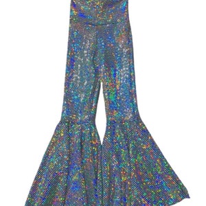 May include: Holographic flared pants with a high waist. The pants are covered in a shimmering, iridescent material that reflects multiple colors. The bell bottoms are wide and flowing, creating a dramatic silhouette.