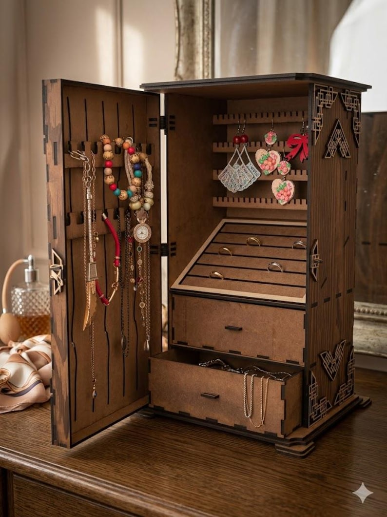 May include: A wooden jewelry armoire with an open door revealing necklaces, bracelets, and earrings. The armoire has multiple compartments, including drawers and earring holders. The wood has a dark brown finish with decorative cutouts.