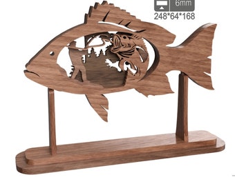 May include: Wooden sculpture of a fish with a fisherman and a fish inside. The sculpture is on a wooden base and is 6mm thick. The dimensions are 248*64*168.
