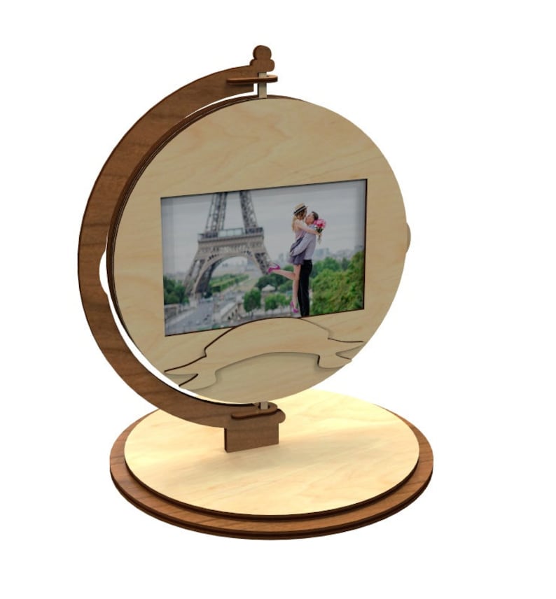 May include: A wooden photo frame shaped like a globe with a picture of a couple in front of the Eiffel Tower. The frame has a ribbon banner at the bottom.