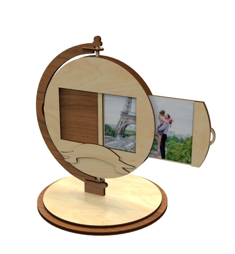 May include: A wooden photo frame shaped like a globe with two photo slots. The frame is made of light wood and has a dark brown base. The frame is designed to hold two photos, one on each side. The frame is a great way to display photos of your travels or special memories.