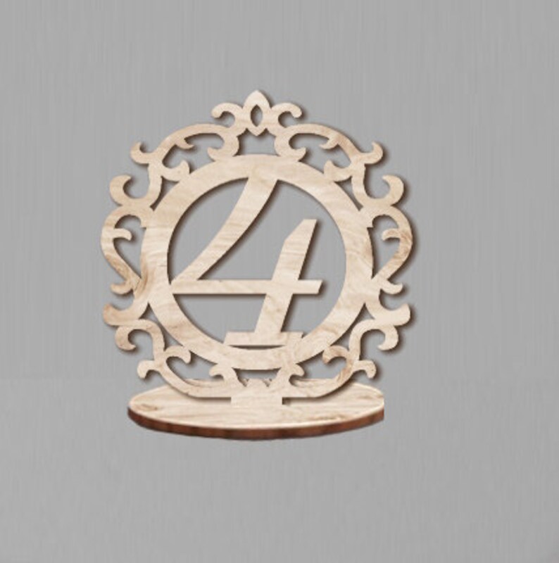 May include: Wooden table number holder with a decorative frame and the number 4 in the center.