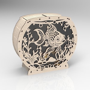 May include: A wooden cutout of a fishbowl with a goldfish inside. The fishbowl is decorated with seaweed and bubbles. The cutout is made of light brown wood and has a black background.