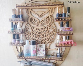 May include: Wooden owl-shaped nail polish rack with multiple shelves. The rack is 50 x 60 cm and 3/6 mm thick. It is filled with various nail polish bottles, nail care products, and accessories. The owl design is laser-cut.