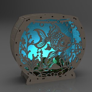May include: A wooden fishbowl night light with a blue glow, featuring a cutout design of a fish swimming among plants and bubbles.