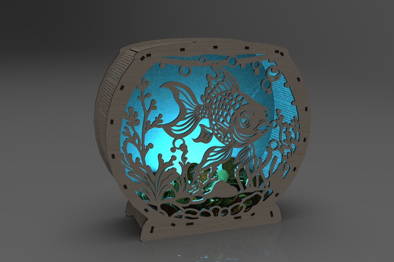 May include: A wooden fishbowl night light with a blue glow, featuring a cutout design of a fish swimming among plants and bubbles.