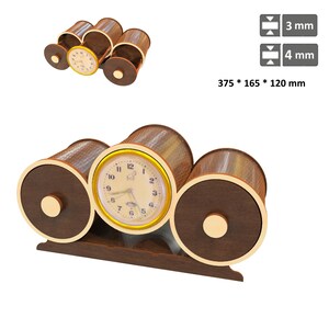 May include: A decorative wooden clock with a gold-colored clock face and hands. The clock has a dark brown base and cylindrical accents. The dimensions are 375 x 165 x 120 mm.