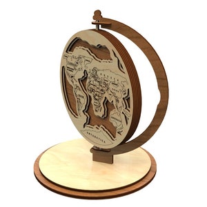 May include: A wooden globe with a world map engraved on it. The globe is on a wooden stand with a base. The globe is made of layered wood and has a brown finish.