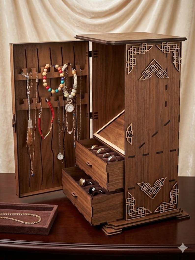 May include: A wooden jewelry box with an open door displaying necklaces and bracelets. The box has two drawers and a small tray. The box is brown with decorative geometric cutouts. The jewelry box is on a dark brown surface.