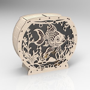 May include: A wooden cutout of a fishbowl with a goldfish inside. The fishbowl is decorated with seaweed and bubbles. The cutout is made of light brown wood and has a black background.