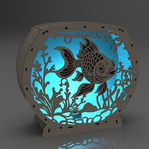 May include: A wooden fishbowl nightlight with a blue light shining through the cutout design of a fish and seaweed.