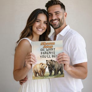 May include: A book titled "Shaun & Amy OH, WHAT PARENTS YOU'LL BE!" is held by a smiling couple. The book cover features illustrations of two bears. The background is a neutral, light colour.