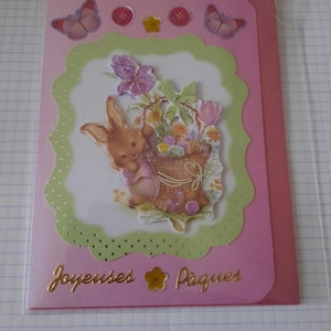 Carte de Paques avec un lapin transportant des oeufs