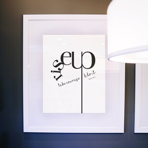 May include: A white framed print with black text that reads "It is up to you to take courage & do it. Ezra 10:4".