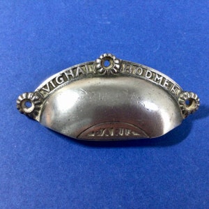May include: Silver drawer pull with the words "Vighal Bodmer" and "Pat'd" engraved on it.