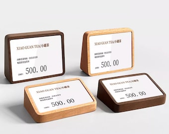 May include: Four wooden display stands with a white card insert. The card has the text "XIAO GUAN TEA/小罐茶" and the price "500.00".