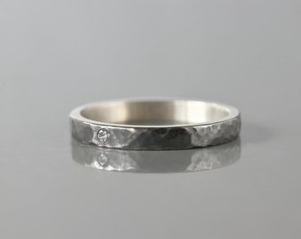 Black hammered ring with small stone