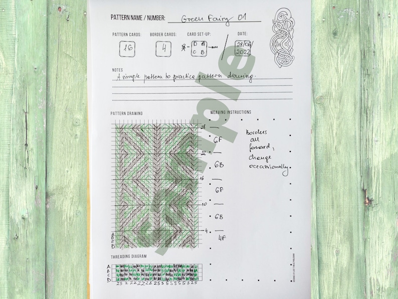 May include: A pattern design sheet named "Green Fairy 01" featuring a green and brown geometric design. The sheet includes pattern cards, border cards, and weaving instructions. The background is a light green wooden surface.