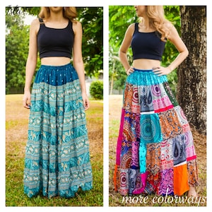 May include: Two women wearing long, patterned skirts with a black crop top. The skirts feature a variety of colors and designs, including paisley and geometric patterns. The text "more colorways" is visible in the image.