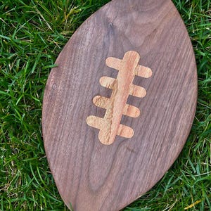 Handcrafted 9 × 15″ Walnut Football Serving & Charcuterie Board with Maple Inlay | Game‑Day Party Gift | Football shaped cutting board |