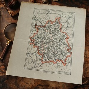 May include: An antique map of Huntington and Cambridge, with a red outline, from the Encyclopedia Britannica, Ninth Edition. The map is on aged paper, with a magnifying glass and other vintage items in the background.