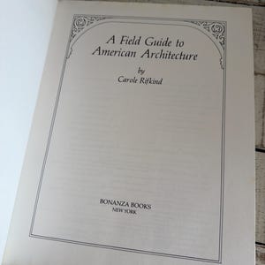 May include: The title page of the book A Field Guide to American Architecture by Carole Rifkind, published by Bonanza Books, New York. The text is printed in black on a white page, enclosed within a thin rectangular border with decorative corners.