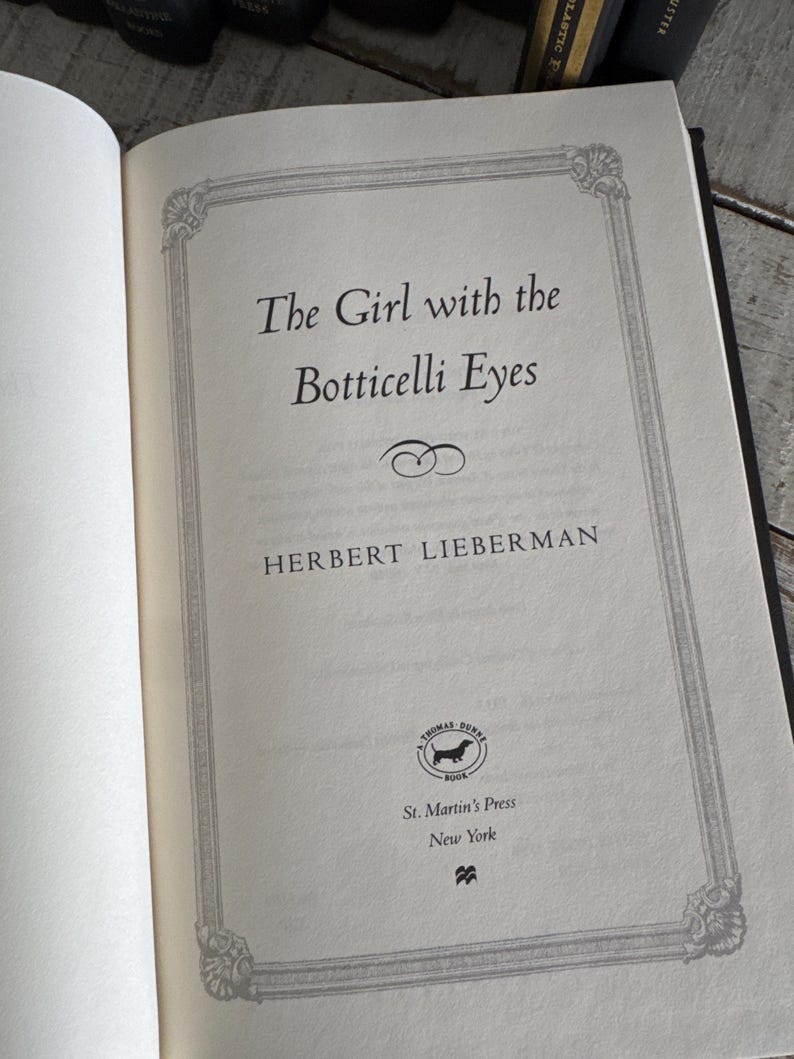 May include: Open book page with the title "The Girl with the Botticelli Eyes" by Herbert Lieberman. The text is in black font, framed by a decorative border. The St. Martin's Press logo is visible.