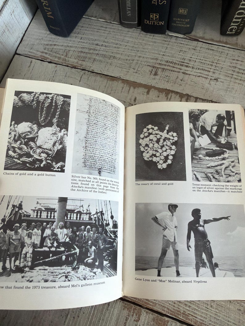 May include: A vintage book featuring black and white photographs. The images depict gold chains, a silver bar, a coral and gold rosary, and a group of people on a ship. Captions include "Chains of gold and a gold button" and "Gene Lyon and "Moe" Molinar, aboard Virgilona."