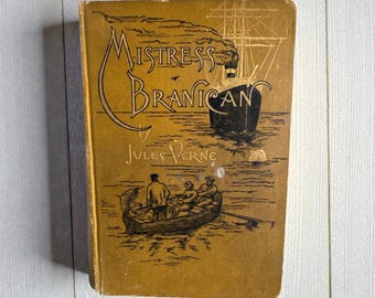 May include: A vintage book titled "Mistress Branican" by Jules Verne. The cover is a faded gold color with illustrations of a ship, a rowboat, and the title in elegant script. The book appears to be an antique.