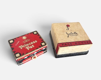 May include: Two vintage square cosmetic boxes. The left box is red with black and gold accents, labeled Princess Pat and Flesh. The right box is cream-colored with a red stripe, labeled Juliette Face Powder, New York-Chicago-San Francisco, Rachel Number One.