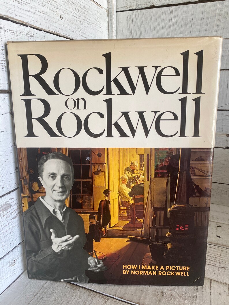 K&ouml;nnte beinhalten: Ein Buch mit dem Titel "Rockwell on Rockwell: How I Make a Picture" von Norman Rockwell. Der Umschlag zeigt ein Schwarzwei&szlig;foto von Norman Rockwell, im Hintergrund ein Gem&auml;lde von ihm in seinem Atelier.