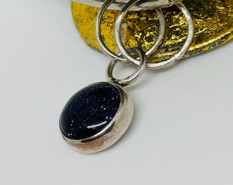 Handmade hammered sterling silver bangle with Blue Goldstone Cabochon.