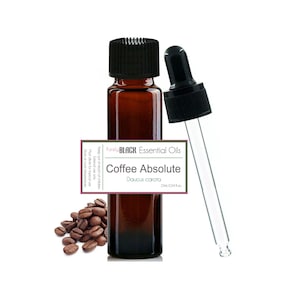 May include: A brown glass bottle of "Coffee Absolute" essential oil with a black cap and a dropper. The label reads "Purely BLACK Essential Oils" and "Daucus carota". A small pile of coffee beans is next to the bottle. The bottle contains 10 ml or 0.34 fl oz.