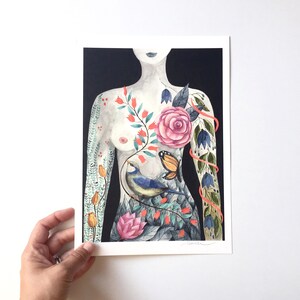 May include: A watercolor painting of a person's torso with a floral design. The design includes a pink rose, bluebells, butterflies, and a blue bird. The background is black.