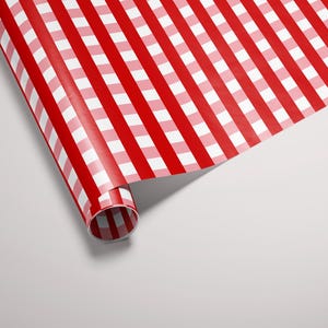 May include: Red and white striped wrapping paper rolled up, ready for gift wrapping.