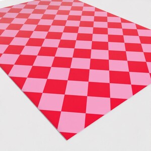 May include: Checkered wrapping paper with a pink and red diamond pattern.