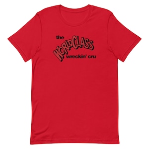 May include: Red t-shirt with black text that reads "the world class wreckin' cru"