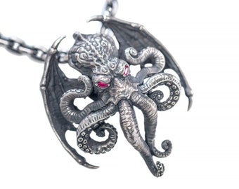 May include: A silver-colored pendant necklace featuring a detailed Cthulhu design. The pendant has red gemstone eyes, wings, and tentacles. The necklace chain is also silver and has a link design. The pendant is a unique piece of jewelry.