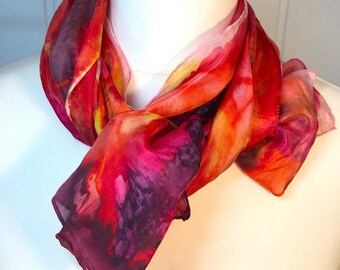 Unique delicate silk scarf is hand painted with vibrant silk dyes on a stretcher frame and then steam set.'Personalised' gift box available.