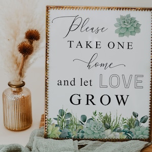 Peut inclure: Une pancarte blanche avec un cadre doré et un motif de succulentes. La pancarte dit "Veuillez prendre un à la maison et laissez l'AMOUR CROÎTRE".