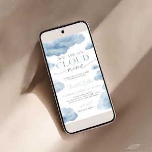 May include: A blue and white baby shower invitation with a watercolor cloud design. The text reads "We are on cloud nine" and includes details about the event, including the date, time, location, and RSVP information.